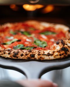 Perforated Pizza Peel with Neapolitan Pizza on top
